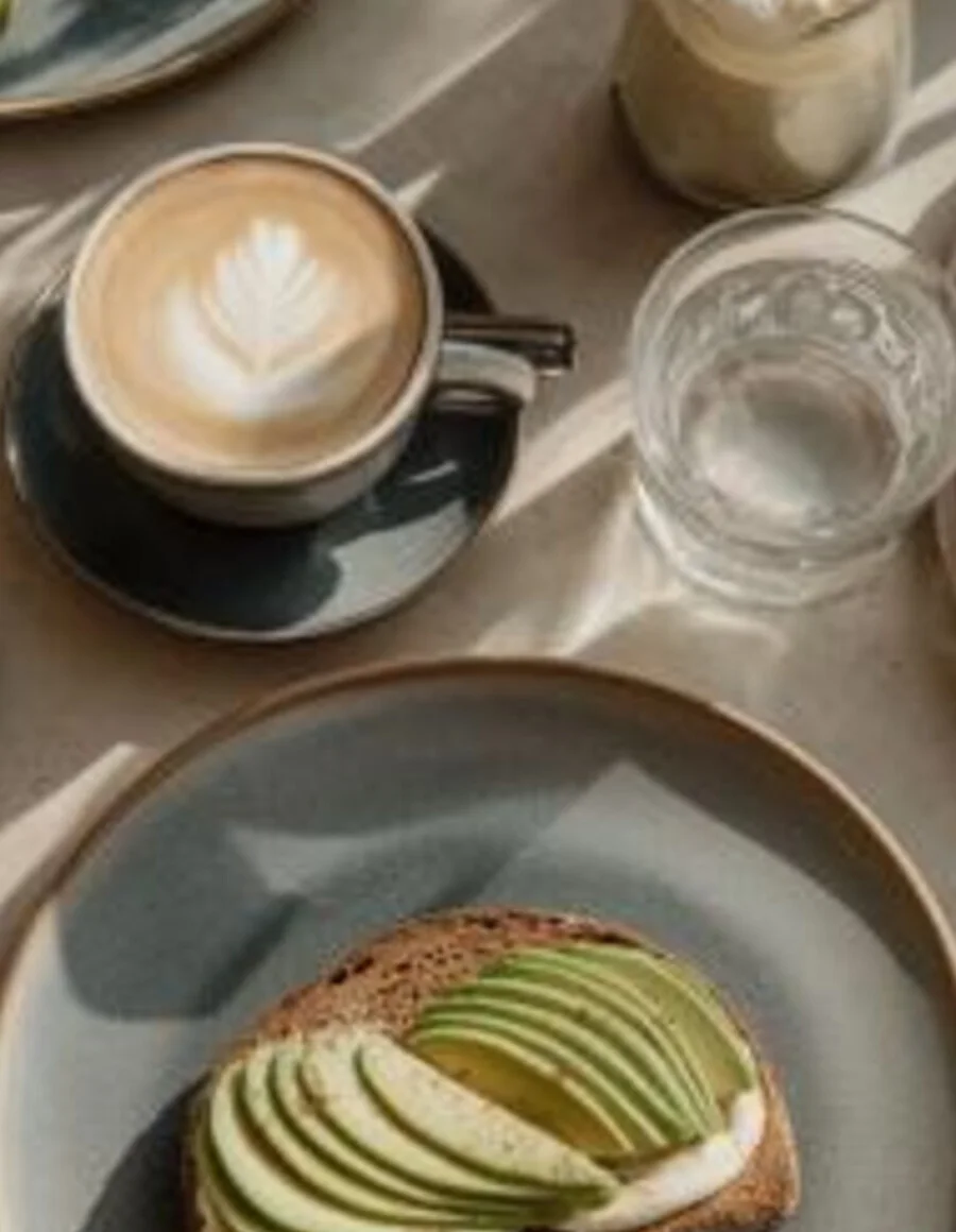 A styled café table with coffee and breakfast